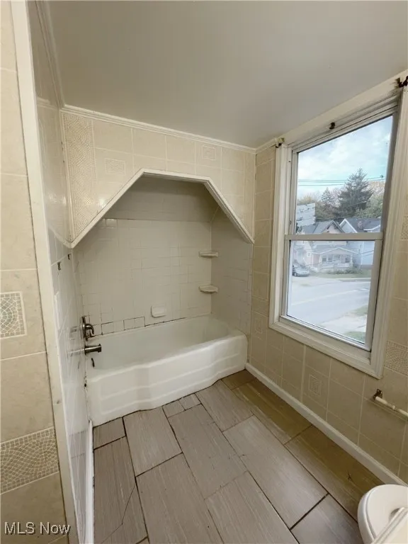 Bathroom with baseboards and  shower combination