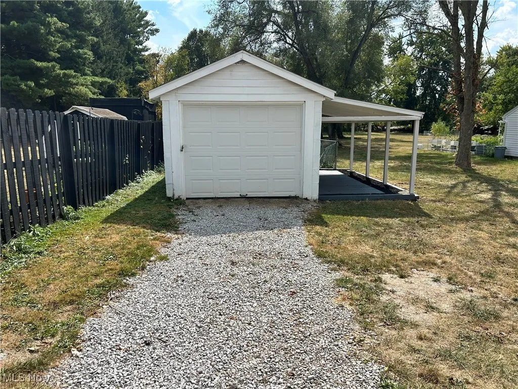 Detached garage with gravel driveway