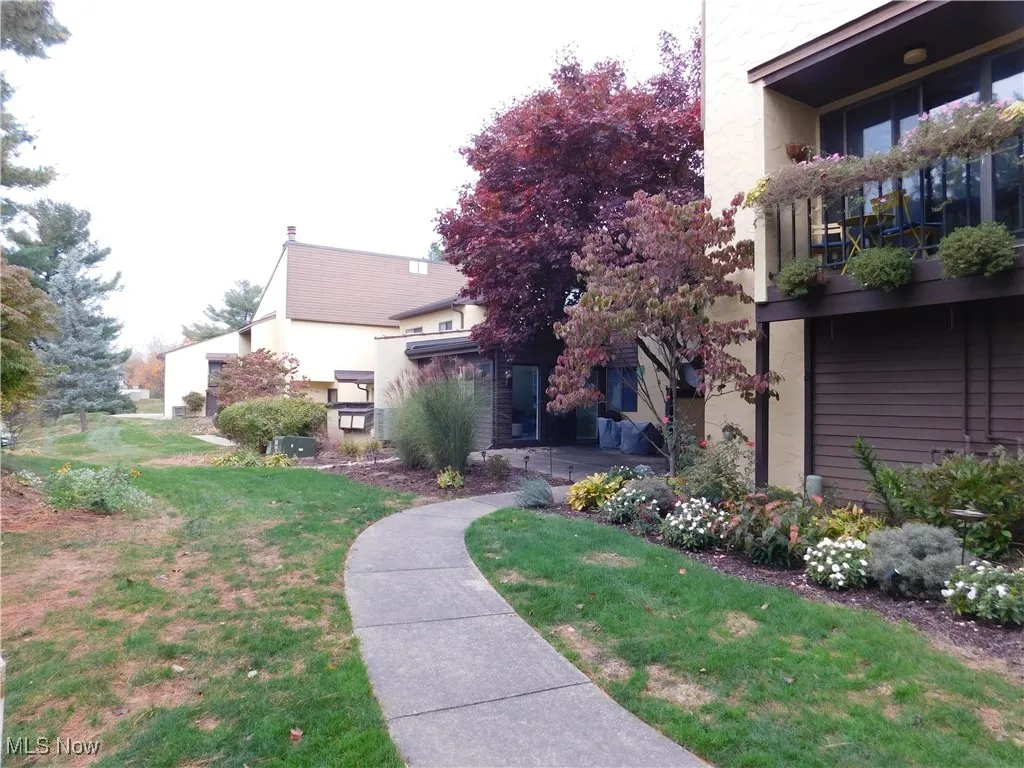 View of grassy common area and walkway to unit's patio