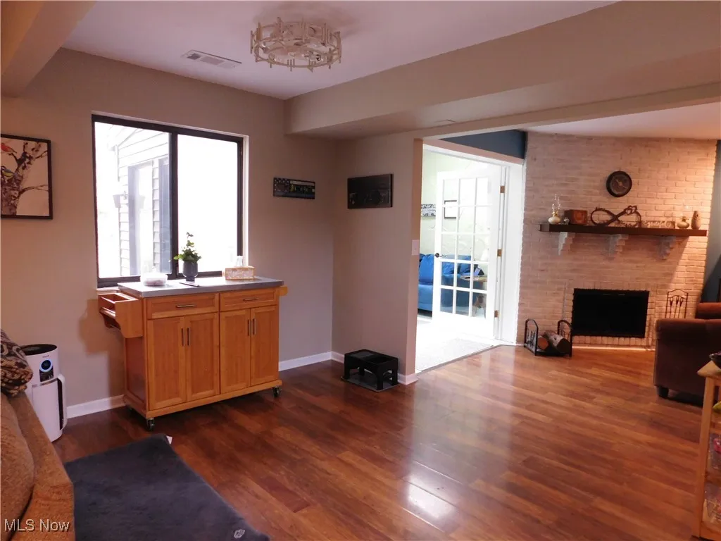 Living room with wood-style flooring and views of the fireplace