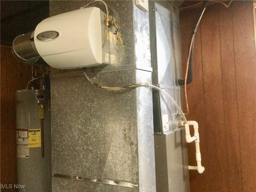 Utility room with water heater and heating unit