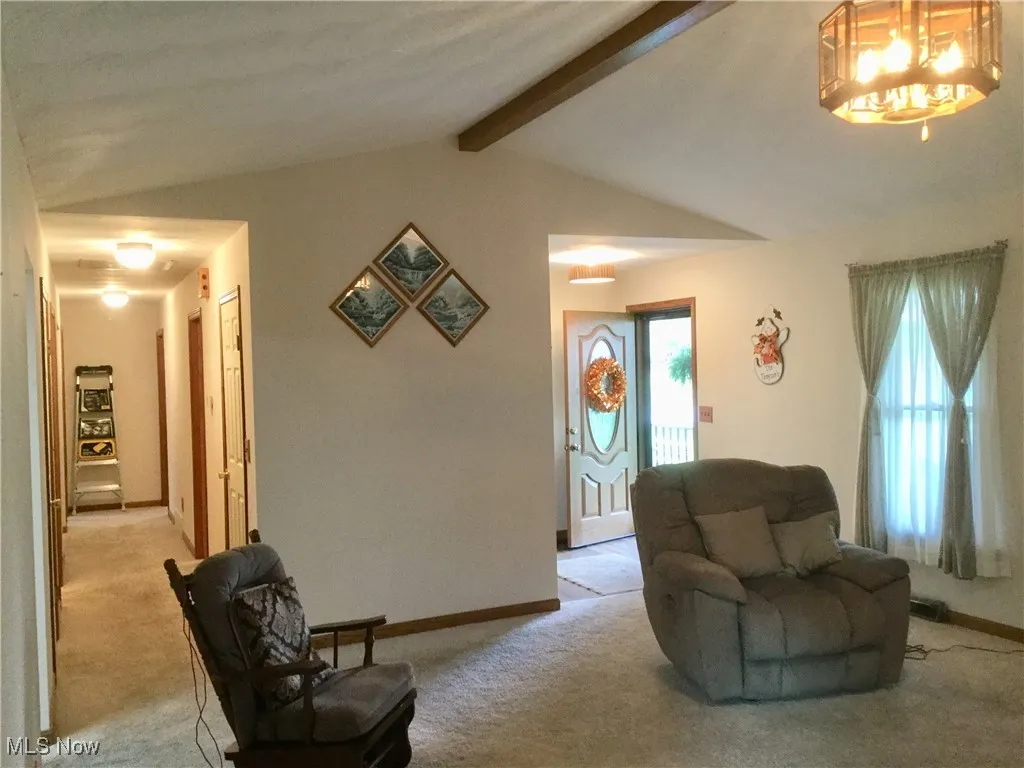 Living room featuring light carpet and baseboards