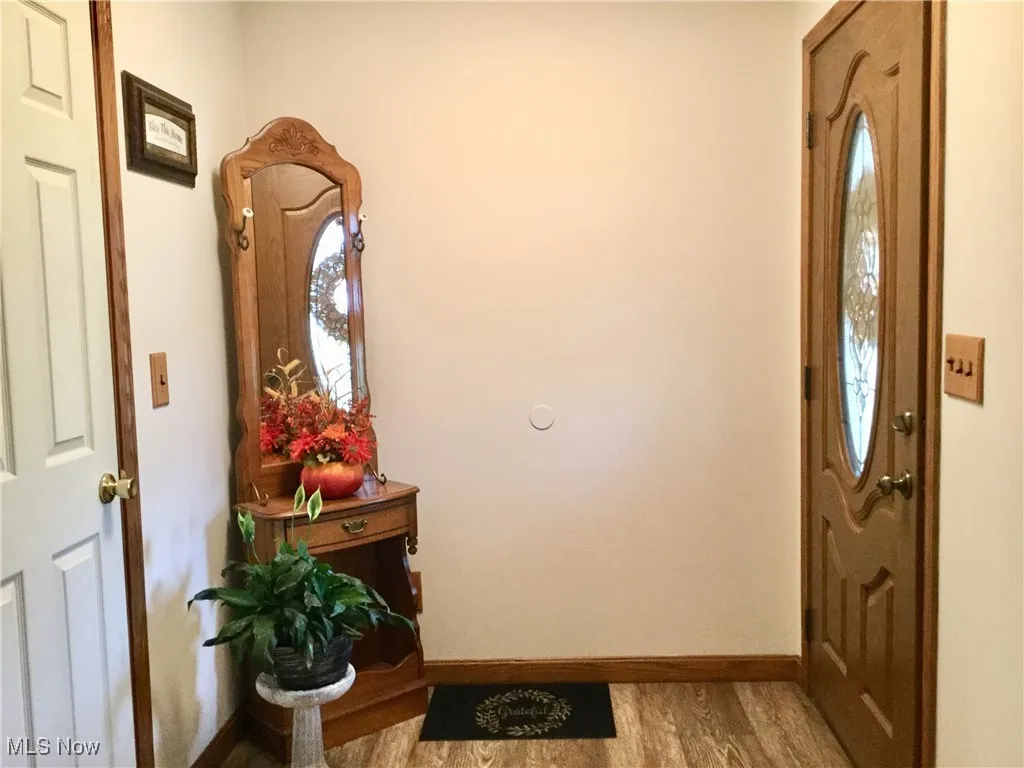 Entryway featuring light wood-style flooring and baseboards