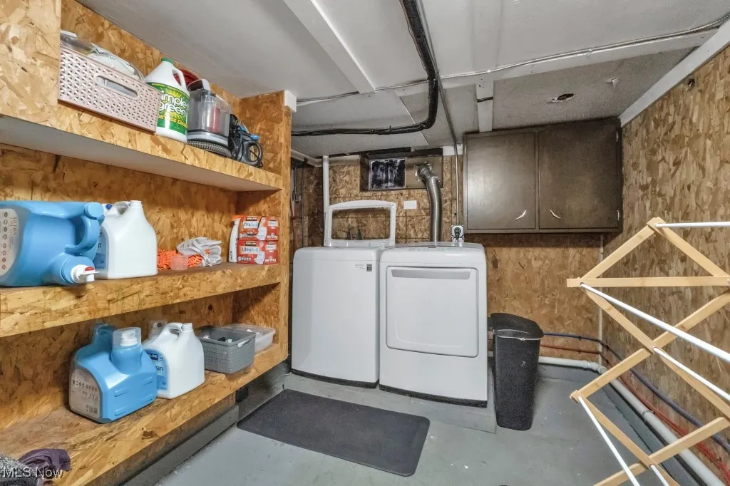 Laundry room featuring washer and clothes dryer and concrete flooring