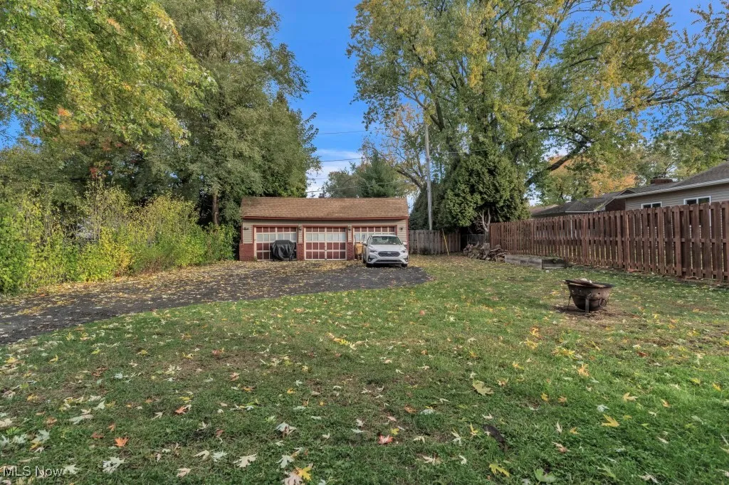 View of yard with a garage and an outdoor structure