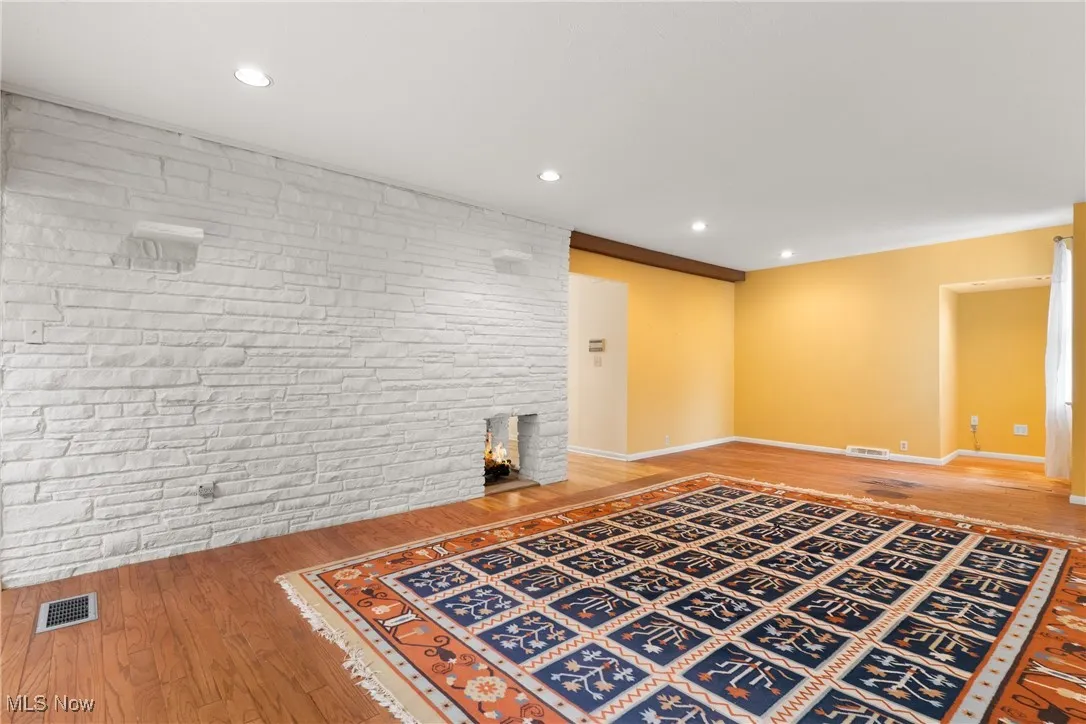 Unfurnished living room featuring light wood-style flooring and recessed lighting