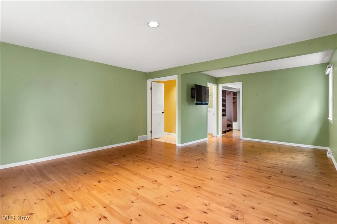 Empty room with light wood-style flooring and baseboards