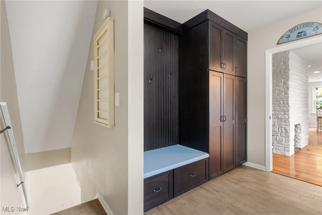 Mudroom featuring light wood-style floors and baseboards