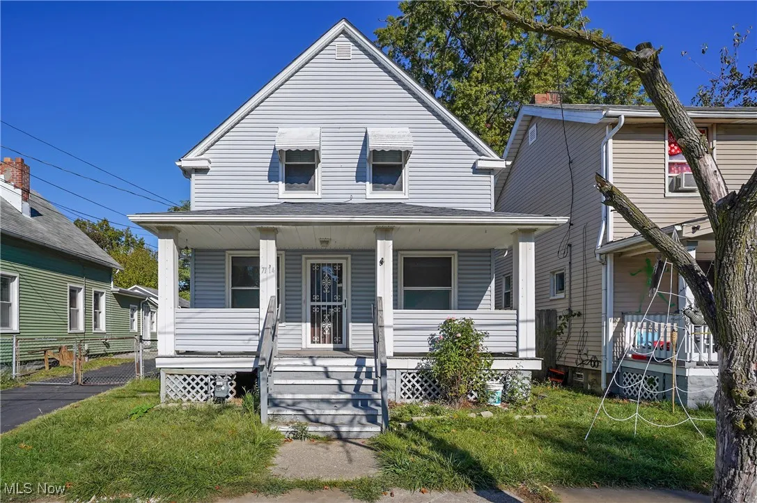 View of front of house featuring a front lawn and a porch