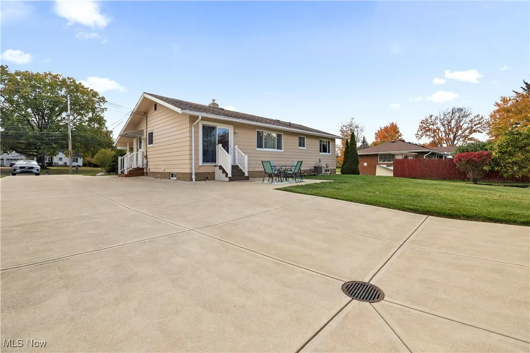 Rear view of property featuring entry steps and a patio