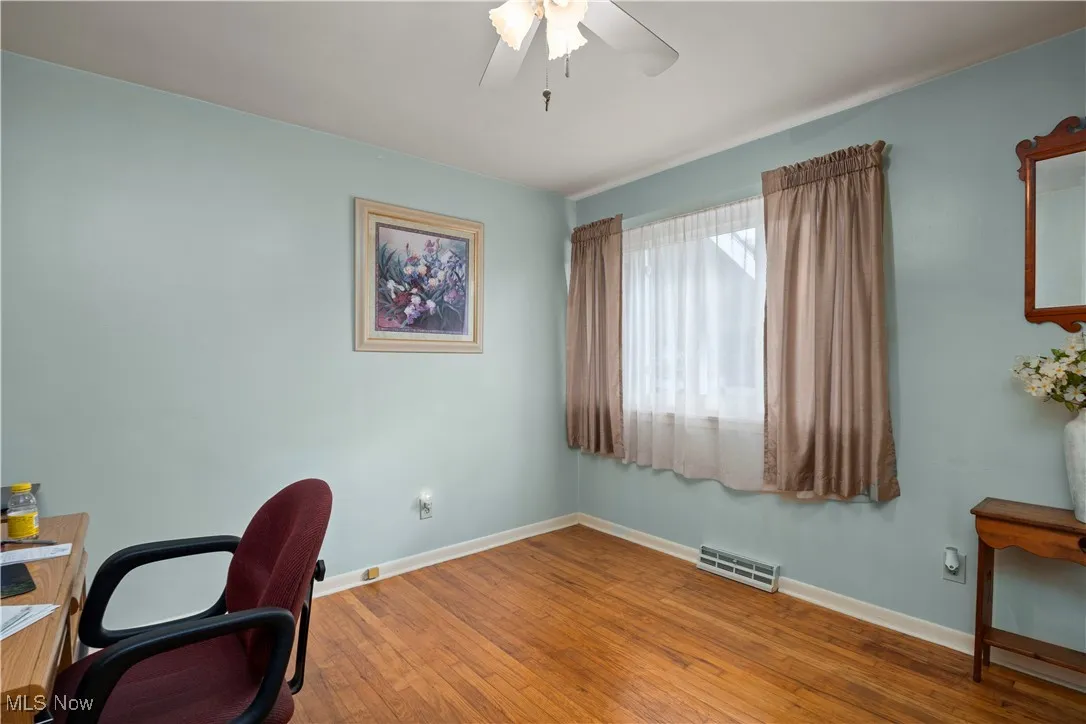 Office space featuring hardwood / wood-style floors and a ceiling fan