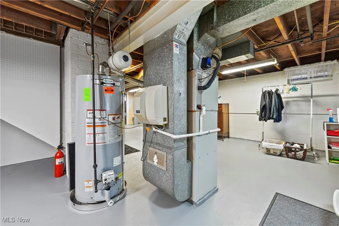 Utility room with gas water heater and heating unit