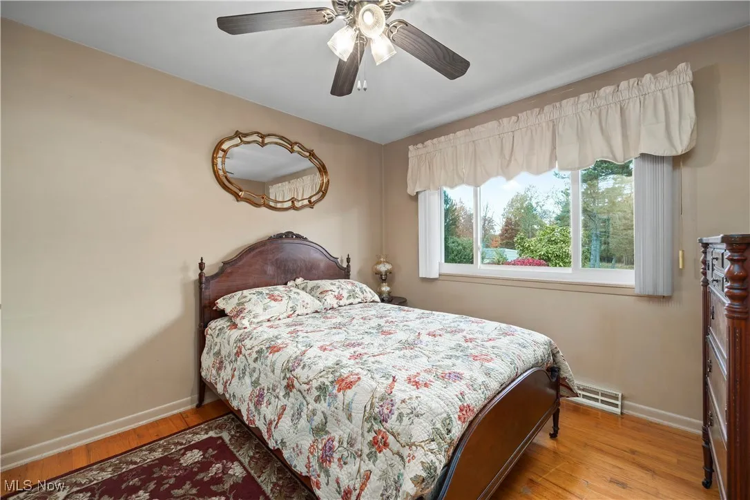 Bedroom featuring light wood-style floors and a ceiling fan