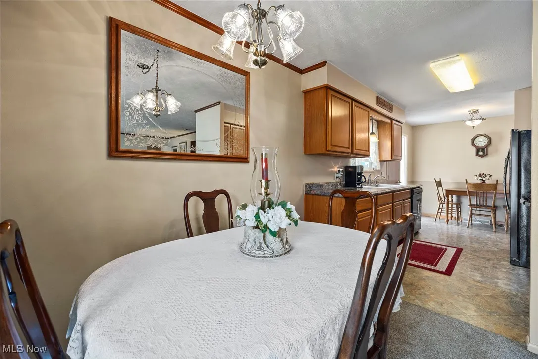 Dining room featuring a chandelier and a textured ceiling