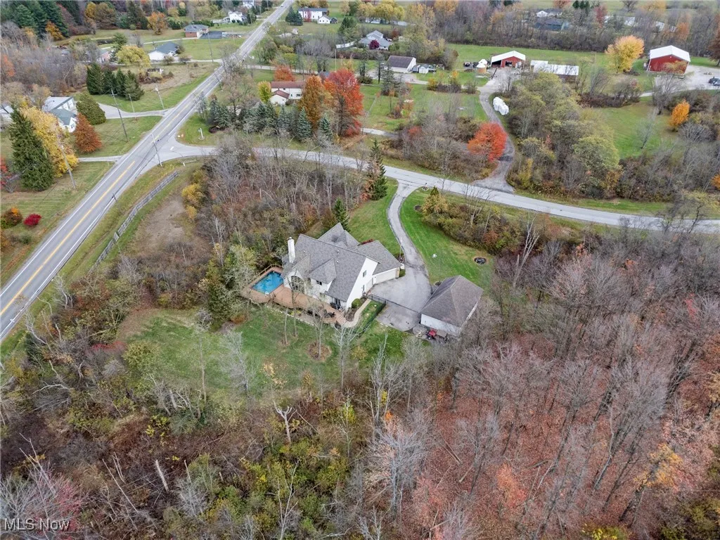 Aerial overview of property's location featuring a tree filled landscape
