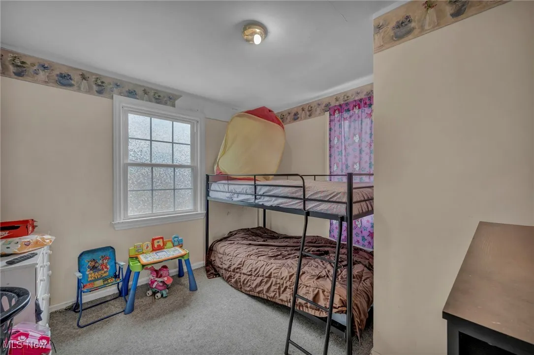 Carpeted bedroom featuring baseboards