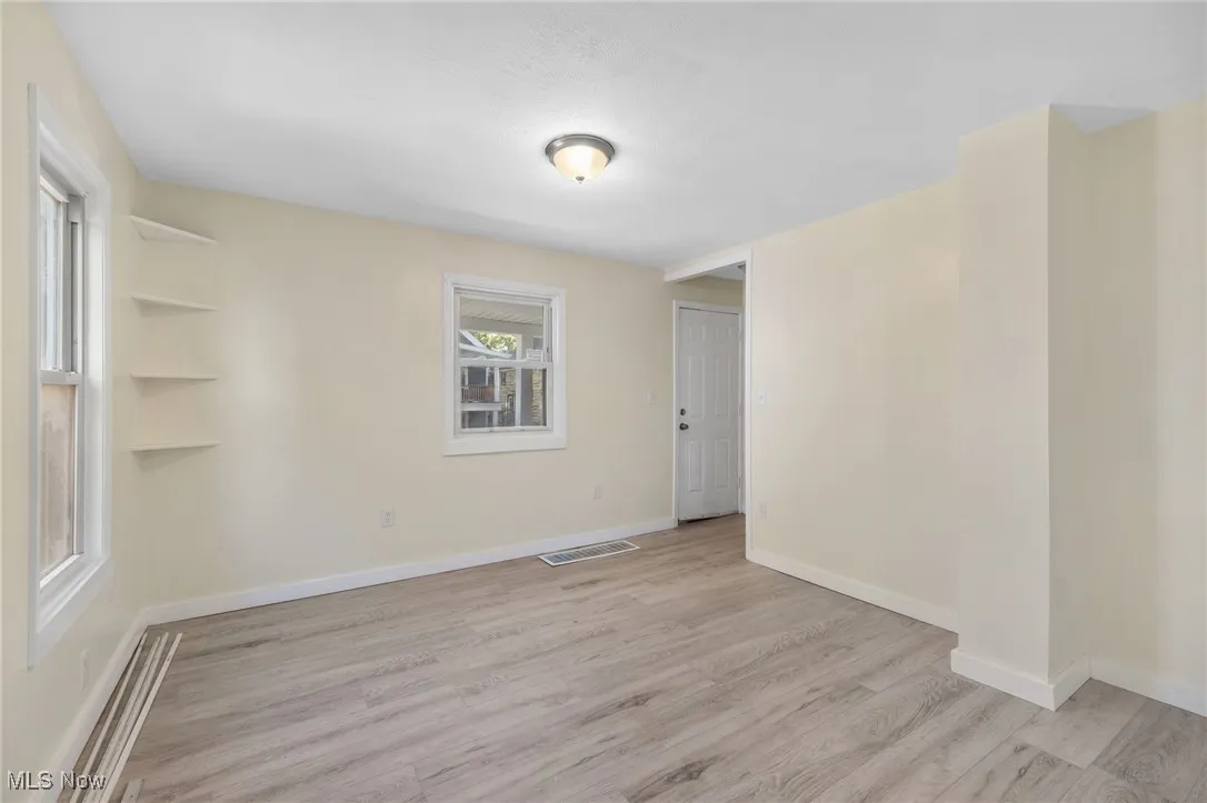 Empty room featuring light wood-style flooring and baseboards