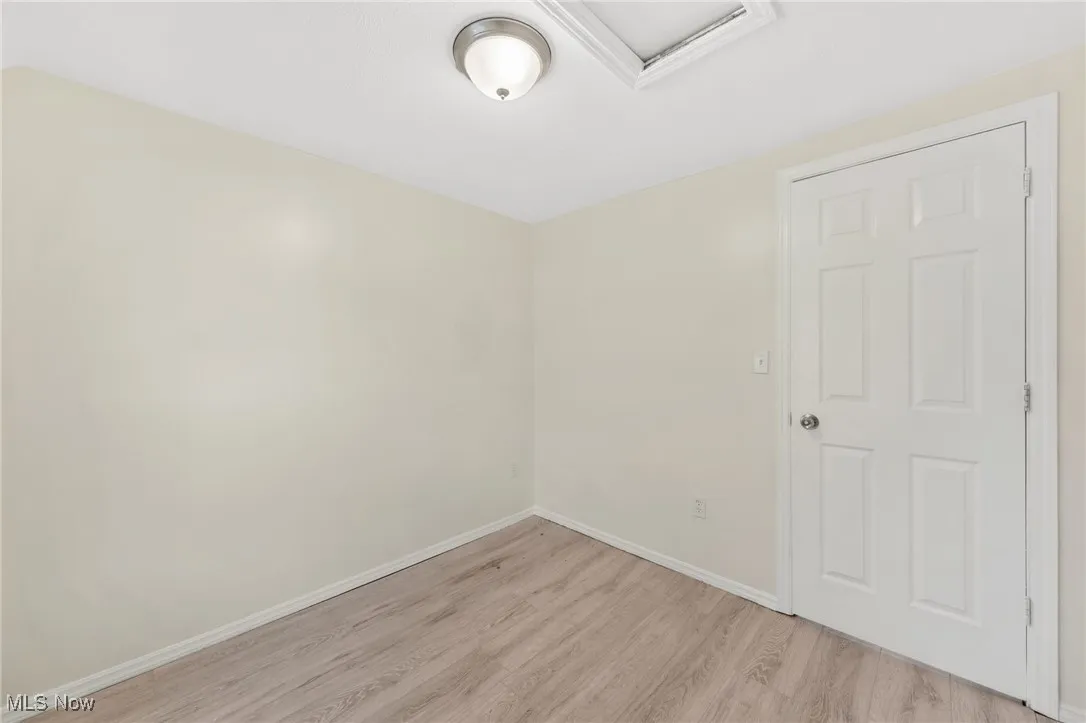 Unfurnished room featuring light wood-style floors and baseboards