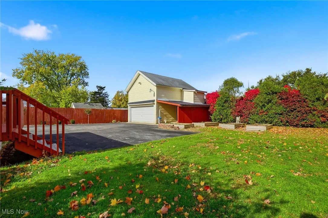 An abundance of paved parking area plus a detached garage and carport