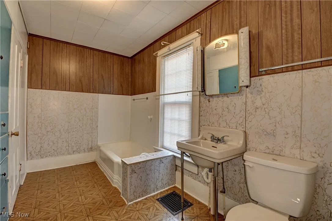 Full bathroom with a bathtub and toilet