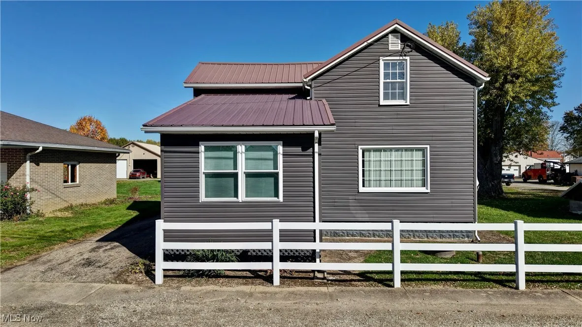 View of property exterior featuring a metal roof