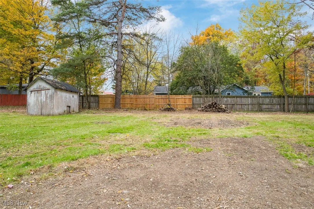 Fenced backyard with a shed