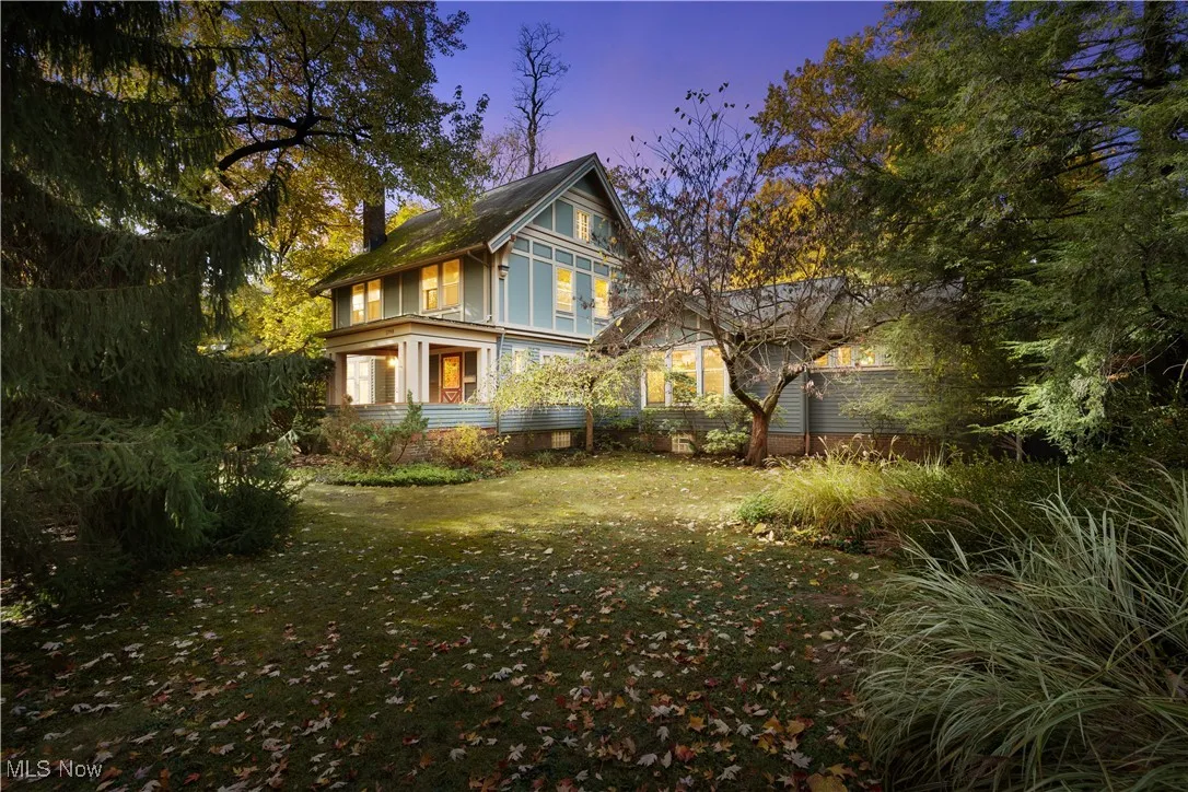 View of property exterior with a yard and a chimney