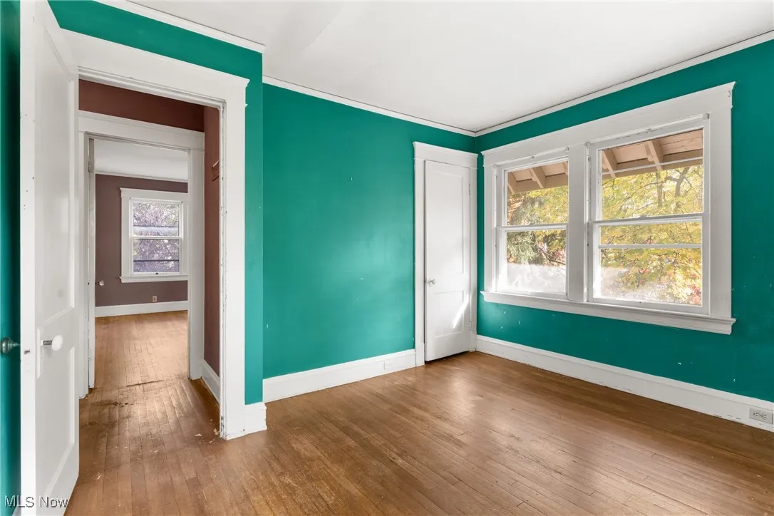 Empty room featuring hardwood / wood-style floors and baseboards