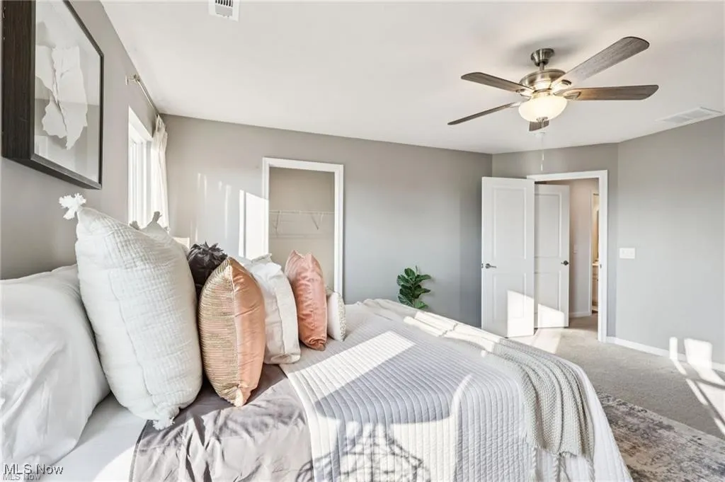 Bedroom with carpet flooring, a ceiling fan, and a closet