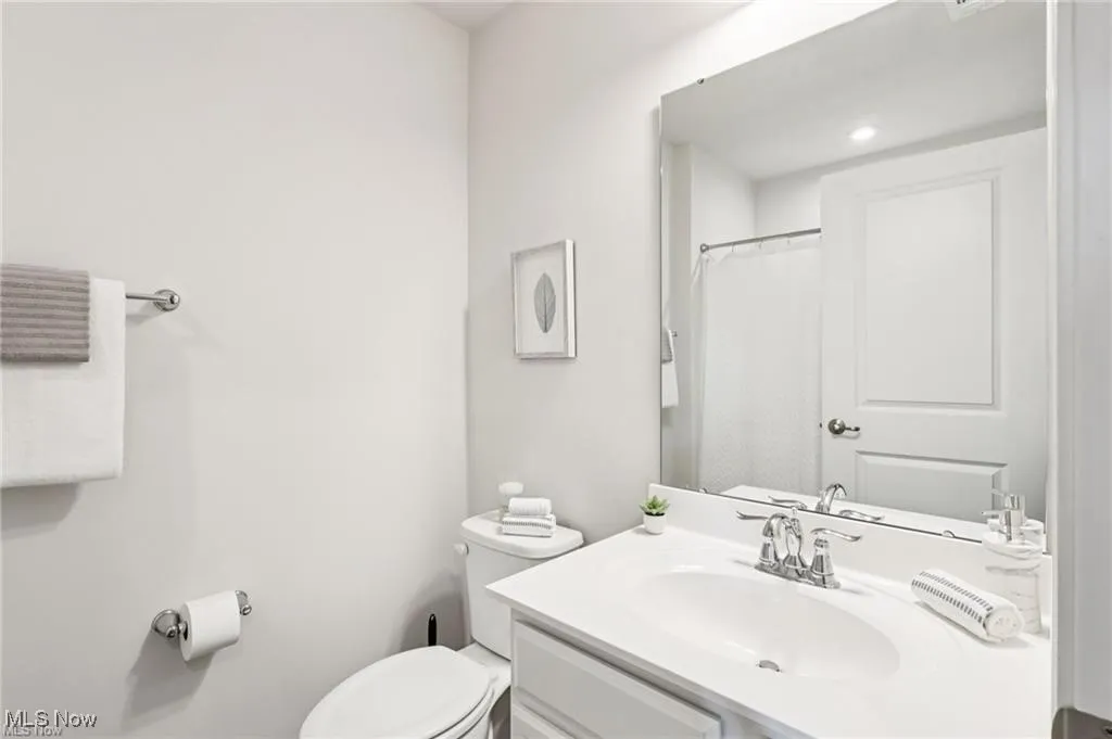 Bathroom featuring vanity and curtained shower