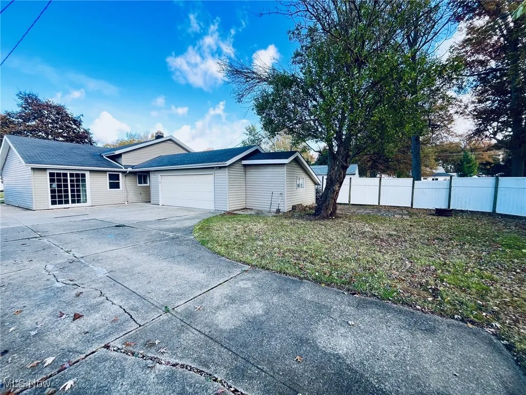 View of side load garage behind house