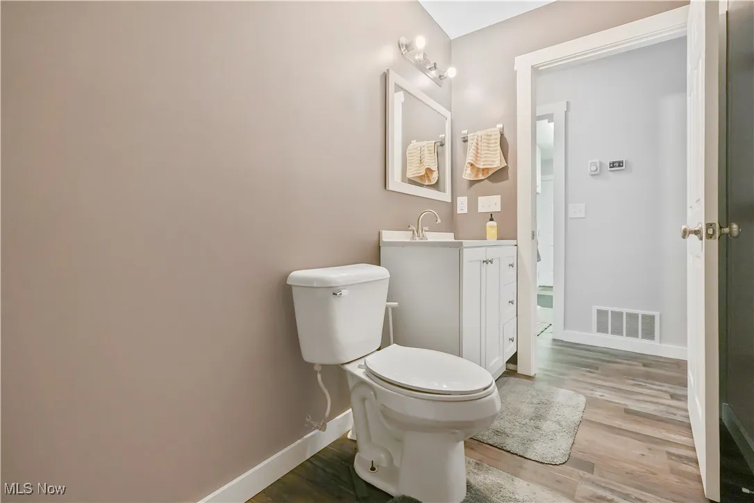 Half bath featuring vanity and light wood-style flooring