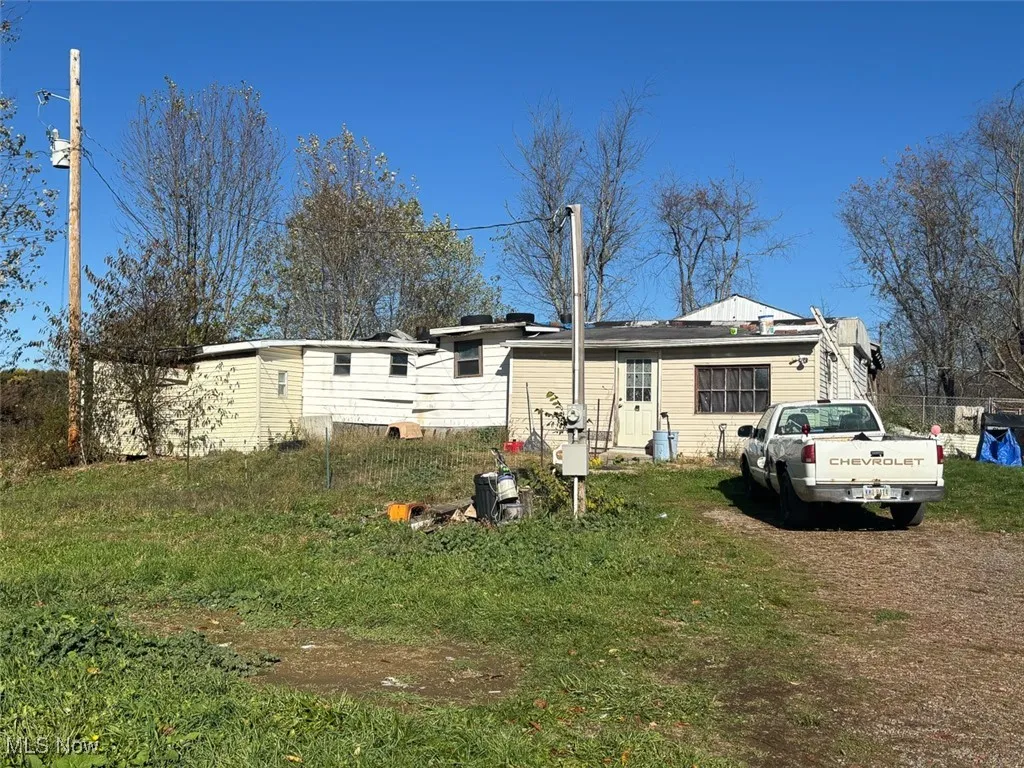 Back of house featuring a lawn