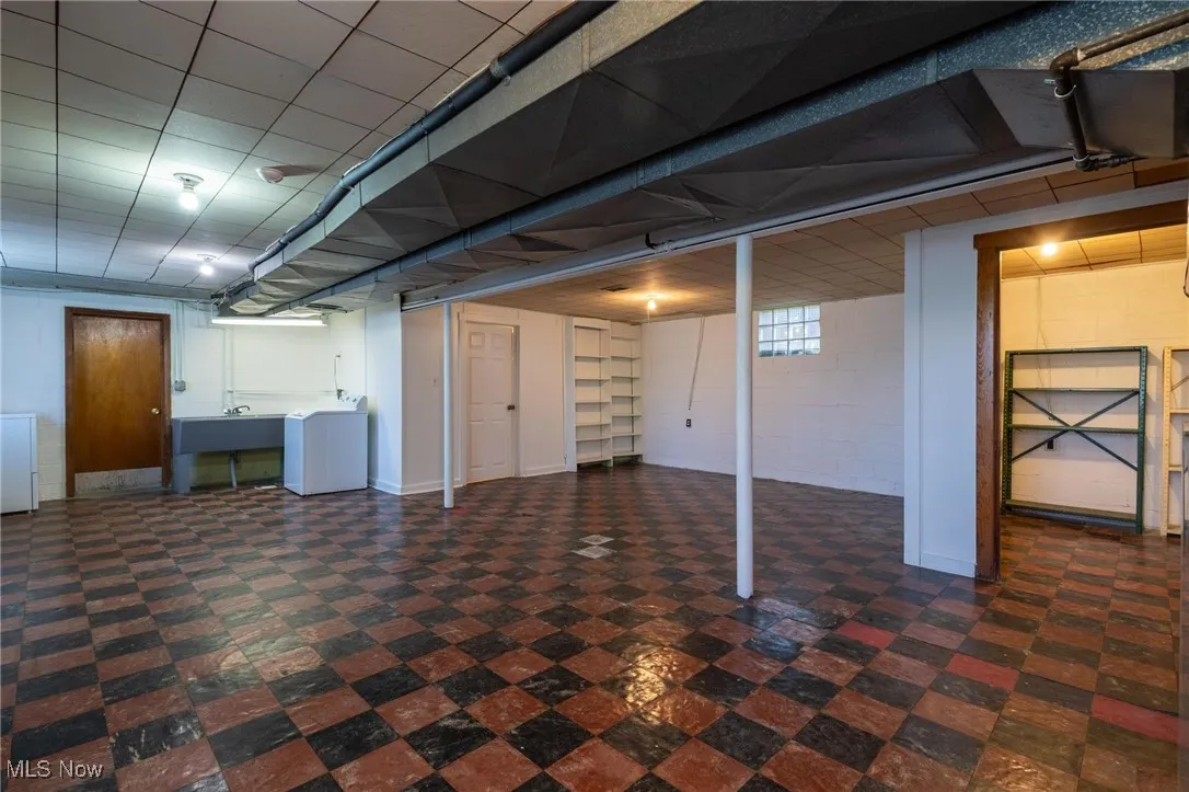 Finished basement featuring dark floors and concrete block wall