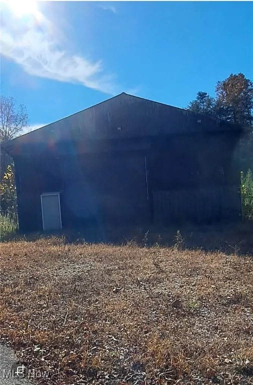 View of home's exterior featuring an outbuilding