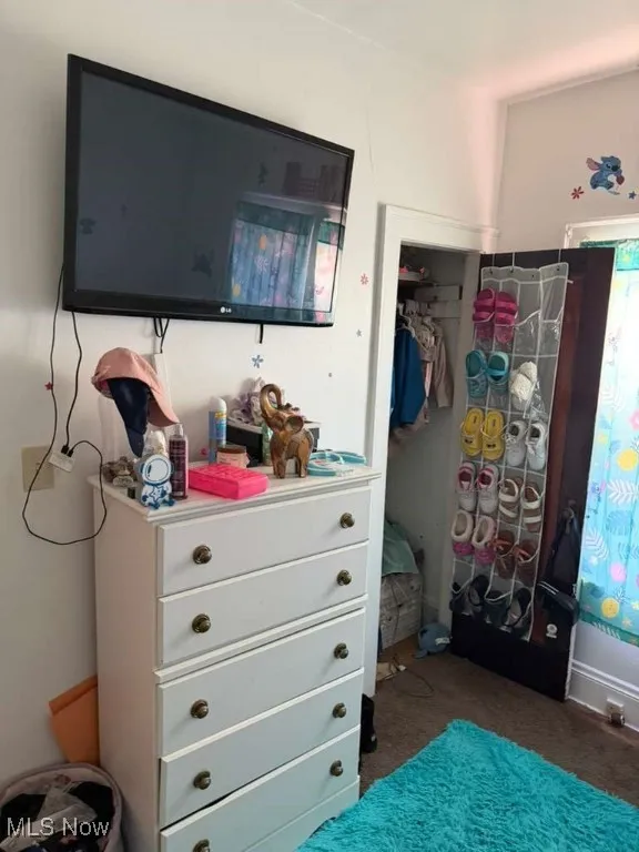 Bedroom featuring a closet and dark carpet