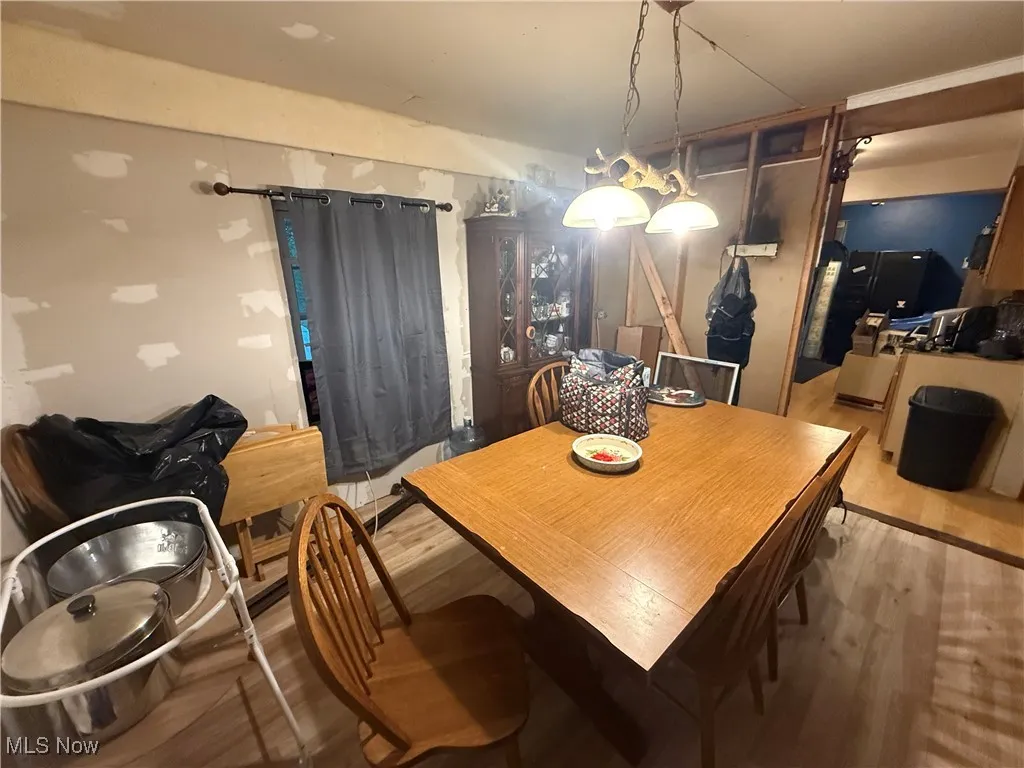 Dining space featuring wood finished floors and a barn door