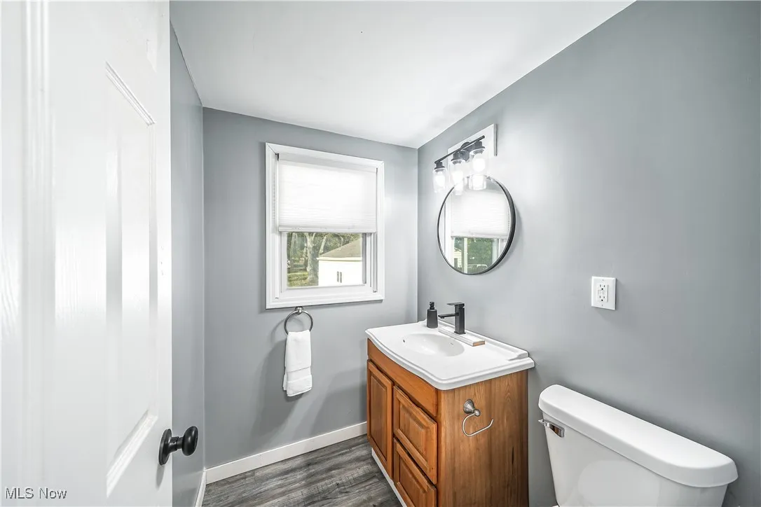 Bathroom featuring vanity and dark wood-type flooring