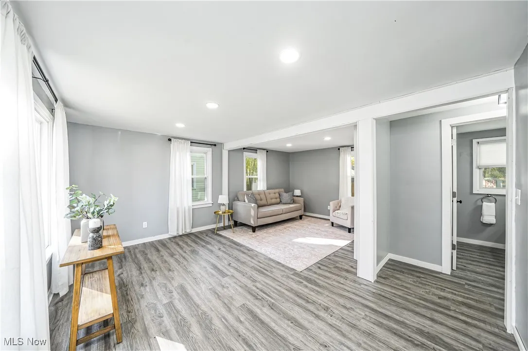 Living area featuring light wood-style flooring and recessed lighting