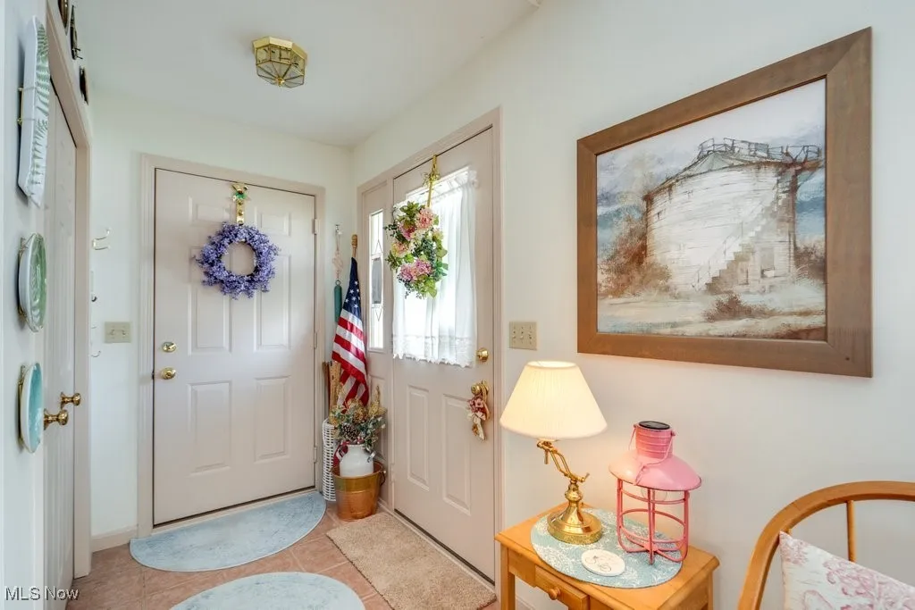 Foyer with ceramic tile flooring and coat closet