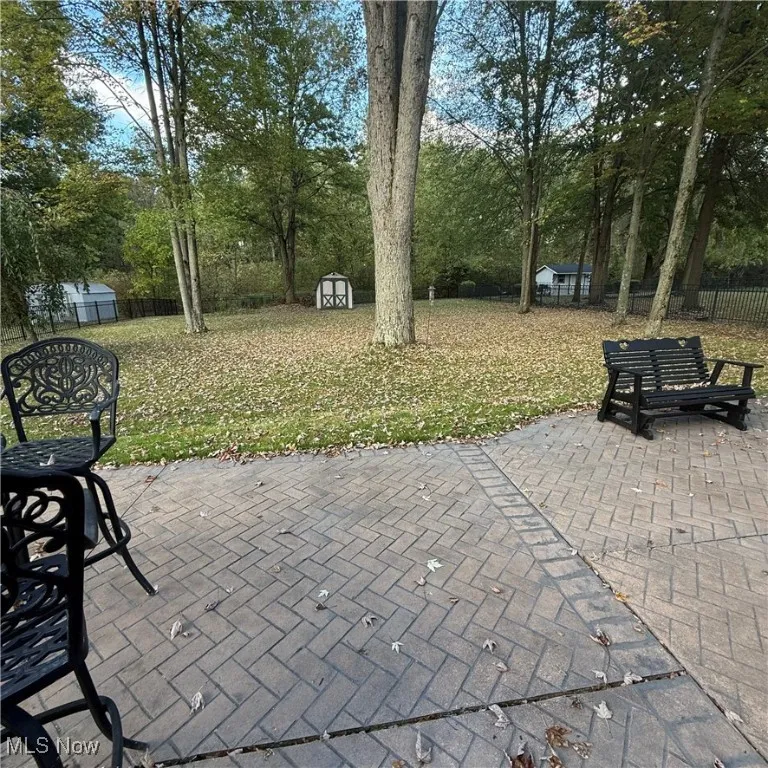 View of patio featuring a storage unit