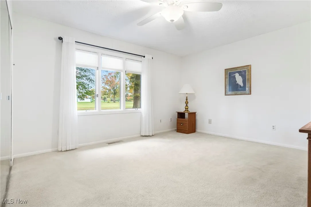Unfurnished room with carpet and ceiling fan