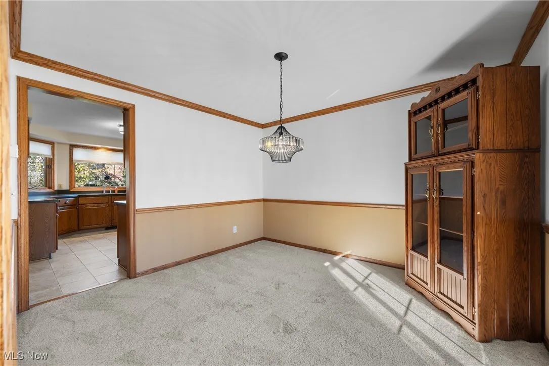 Neutral dining room opens into the kitchen