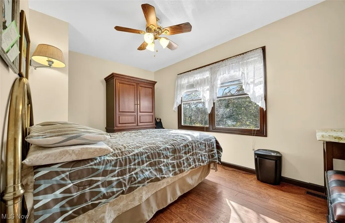 Bedroom with light wood-style flooring and a ceiling fan
