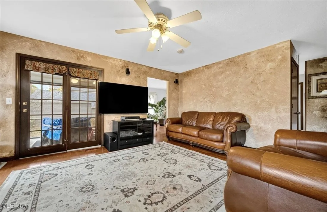 Living room with wood finished floors and ceiling fan