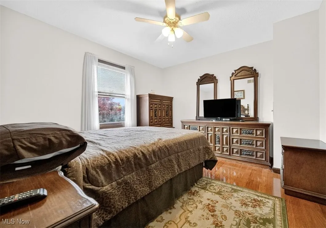 Bedroom featuring wood finished floors and ceiling fan