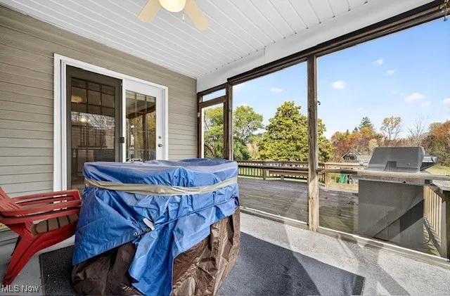 Sunroom featuring ceiling fan