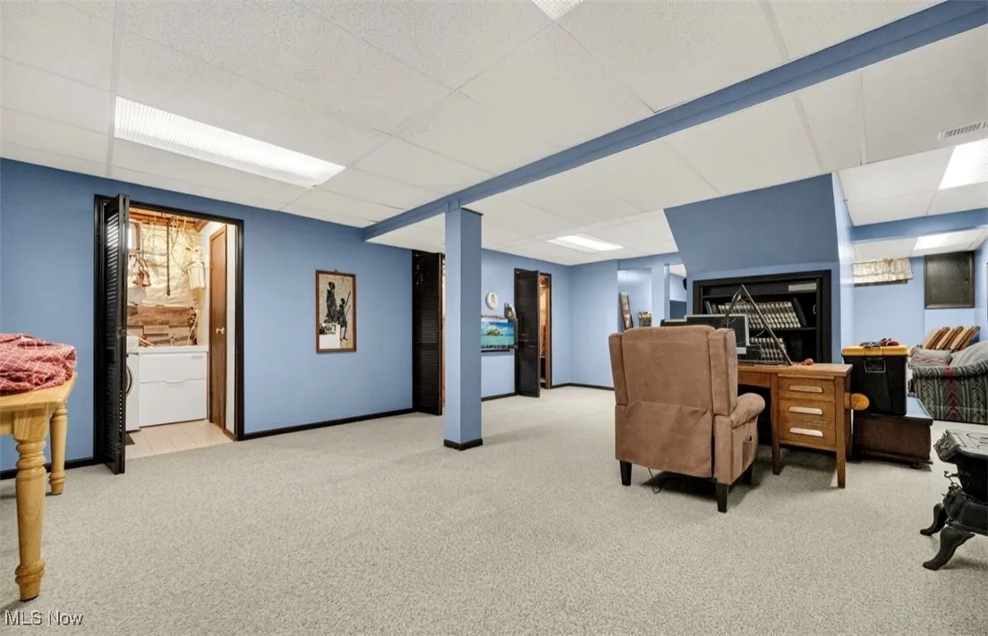 Office featuring carpet, a drop ceiling, and washing machine and dryer
