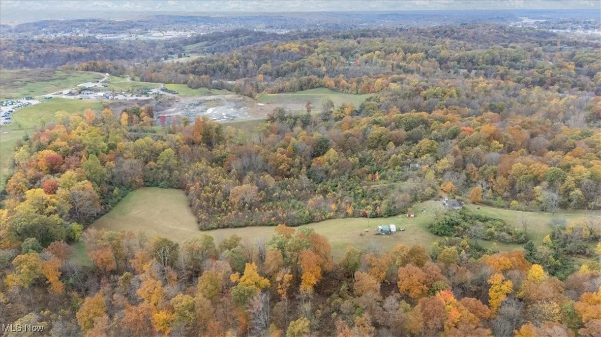 Aerial view of property's location with a forest
