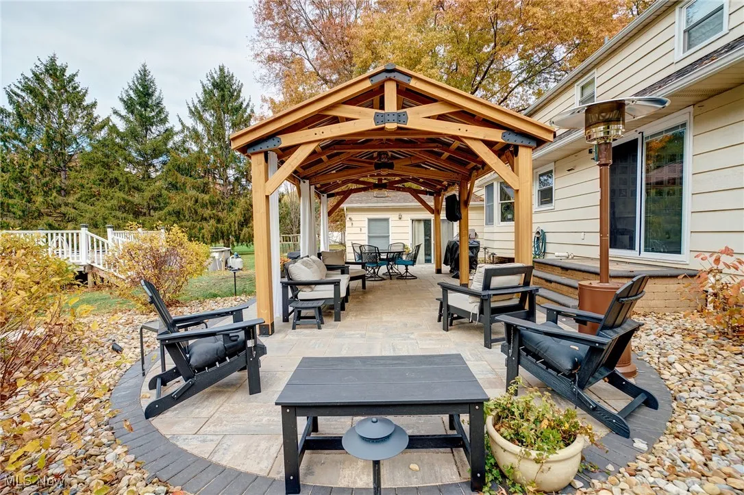 View of patio featuring a gazebo, a grill, outdoor lounge area, and outdoor dining area.